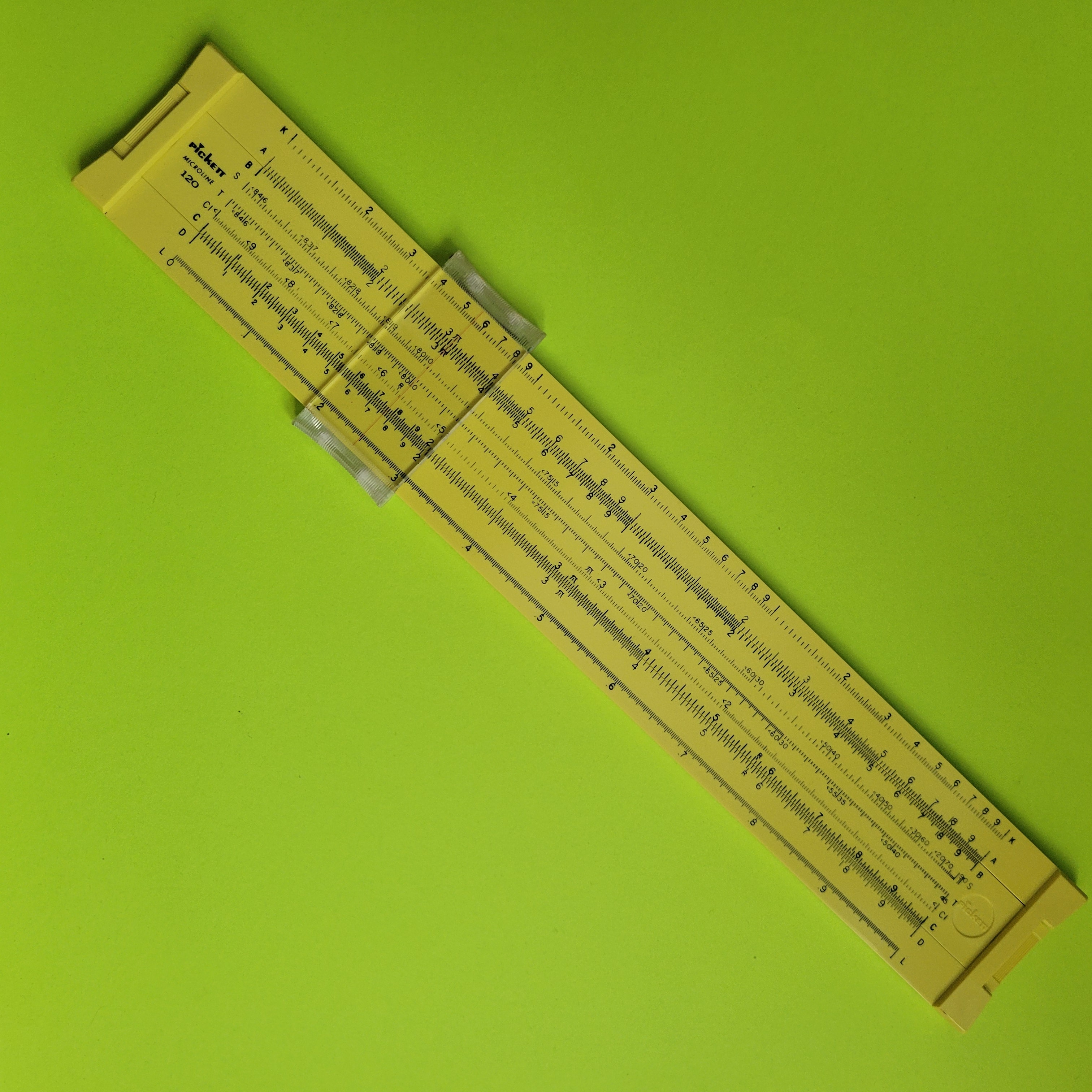 An image of a yellow Pickett Microline 120 slide rule